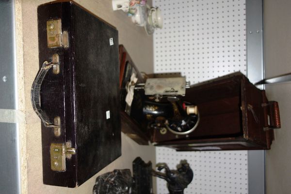 An early 20th century singer sewing machine and a small black leather case. (2)  S1M