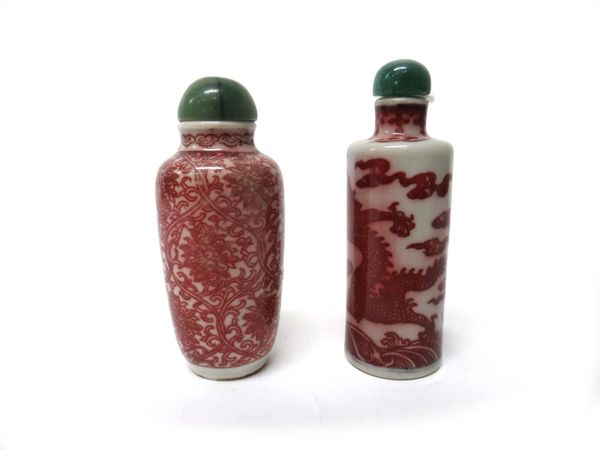 A Chinese porcelain cylindrical snuff bottle, late 19th/20th century, painted in underglaze-red with two dragons amongst breaking waves, 7.5cm. high;