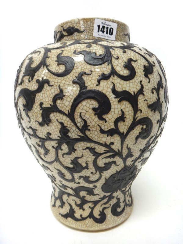 A Chinese crackleware baluster vase, late 19th century, decorated in relief with brown lotus meander, 32cm. high.