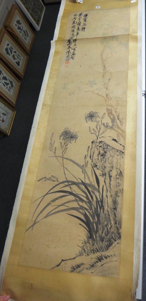 A Chinese hanging scroll painting of lilies, 19th century, ink and slight colour on paper, inscribed and with two seals, 170cm. by 45cm.