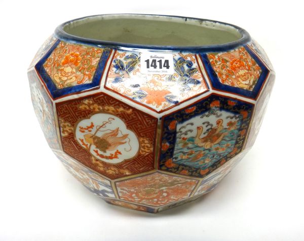 A Japanese Imari jardiniere, Meiji period, moulded with hexagonal panels enclosing animals, mythical beasts, birds and flowers, 25.5cm.high.