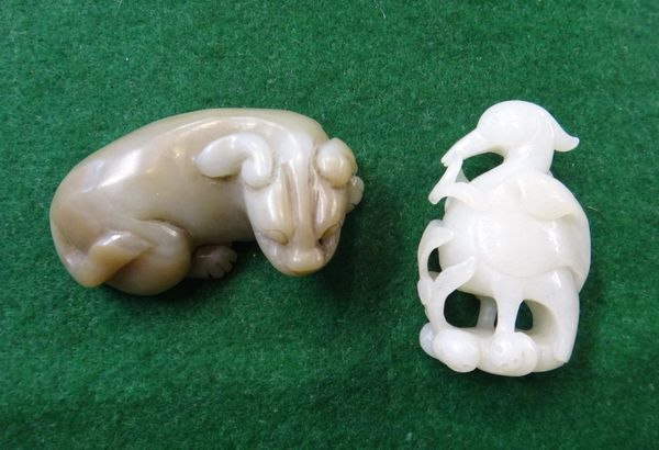 Two Chinese jade carvings of animals, comprising; a Ming-style green and russet jade recumbent lion, 7.5cm. length, and a white jade carving of a bird