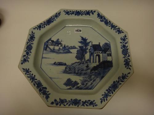 A Chinese export  porcelain blue and white octagonal deep dish, Qianlong, painted with a central river landscape beneath a border spaced with flower s