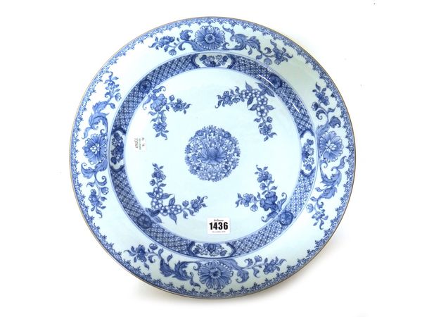 A large pair of Chinese export porcelain blue and white dishes, Kangxi, each painted with a central foliate roundel inside four floral sprays, beneath