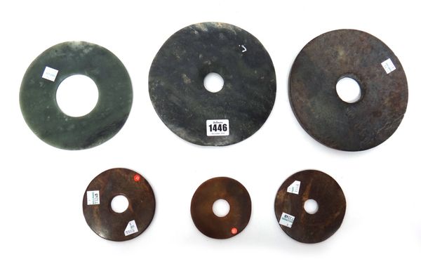 A group of six Chinese jade bi discs of various colour and size, 8.5cm. to 18.5cm. diameter.