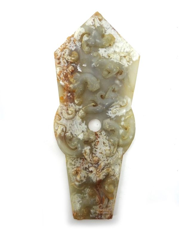 A Chinese jade gui, carved on one side in high relief with chilong, the reverse as a bi disc between taotie masks, 29cm.high.