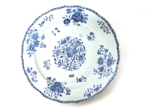 A large Chinese export blue and white dish, 18th century, painted with flower groups inside a diaper pattern border and scalloped rim, 41cm.diameter.