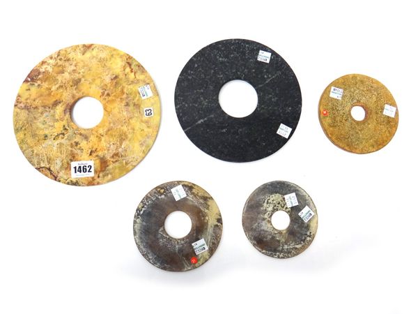 A group of five Chinese archaistic jade bi discs, each plain and of various tones, 11cm.diameter to 21cm. diameter.