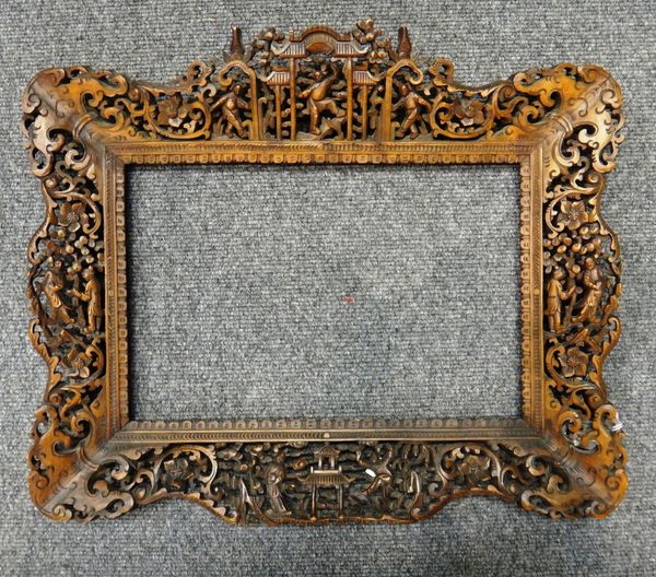 A Chinese pierced and carved wood frame, late 19th/20th century, carved with figures amongst pavilions, trees and flowers, 39cm. by 47cm. overall; als