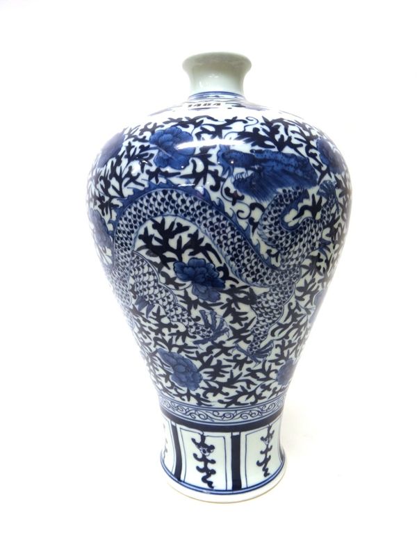 A Chinese blue and white baluster vase, painted with a dragon and phoenix amongst flowering peony, apochryphal Qianlong seal mark, 39cm.high