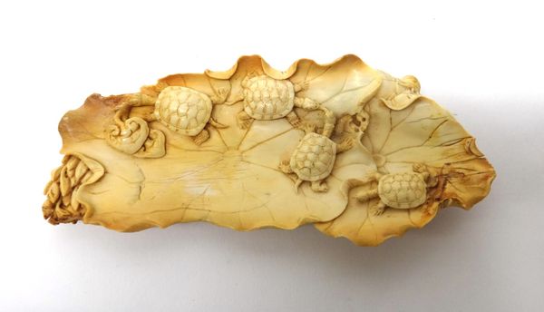 A Japanese ivory carving, Meiji period, depicting four terrapins on lotus leaves, the underside carved with an insect, lotus, a gourd and bamboo, (a.f