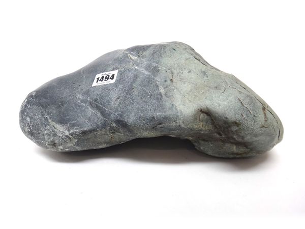 A large uncarved jade boulder, the stone of bluish grey, green and white tones, 31cm. wide, weight 22lbs ( 9979 grams).