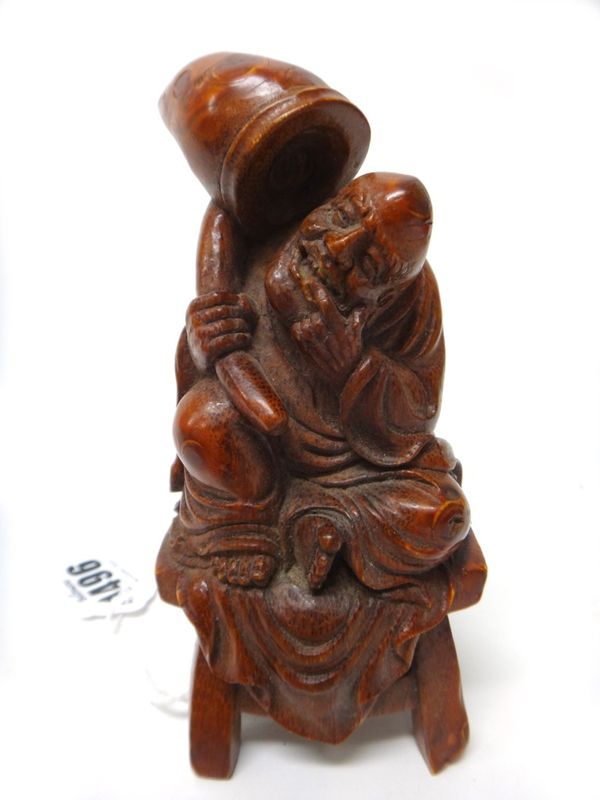 A Chinese bamboo carving of a man seated on a stool, 13cm.high.