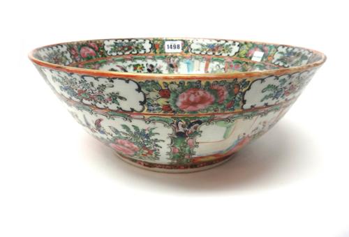 A Canton famille-rose bowl, circa 1900, painted with panels of figures and birds and insects amongst flowers, (a.f), 25cm. diameter.