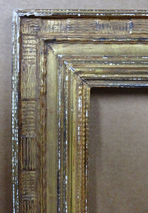 A 20th century gilt plaster frame, with running wave decoration, aperture 128cm x 102.5cm.