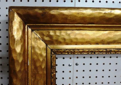 An early 20th century gilt plaster frame, of plain design, aperture 113cm x 143cm.