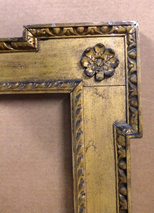 An 18th century style frame of Architectural form, with egg and dart moulding, scrolls and florets, aperture 96cm x 85cm.