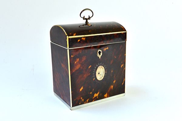 A George III ivory and silver mounted tortoiseshell tea caddy, with dome top and loop handle, 9cm wide x 11cm high. Illustrated.