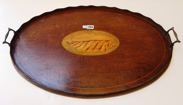 A 19th century conch shell inlaid mahogany oval serving tray, with wavy gallery, 68cm wide.
