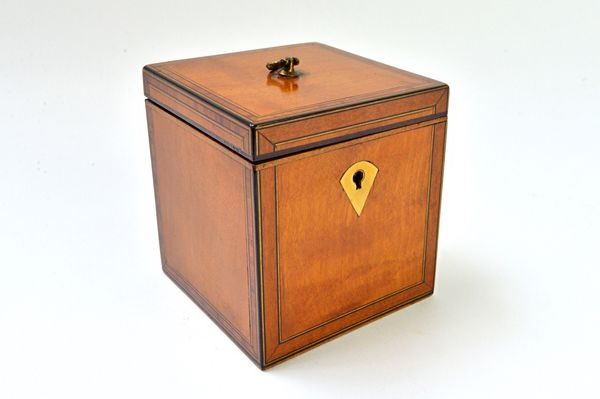 A George III crossbanded satinwood cube tea caddy with loop handle, 10cm wide. Illustrated.