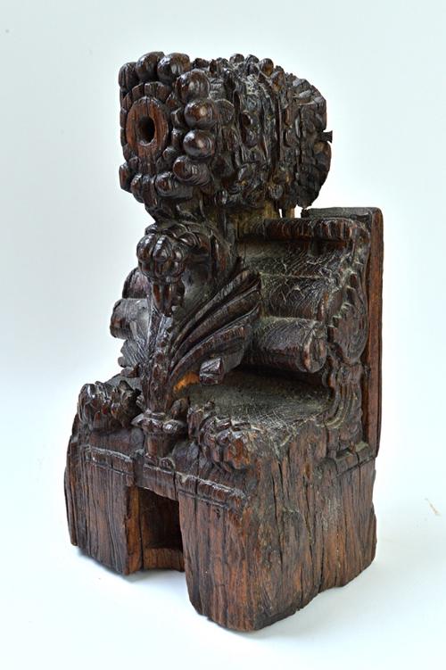 Carvings; an oak ceiling boss relief carved with a ho-ho bird, probably 17th century, 33cm high, two mounts one carved with lions, 13cm wide, the othe