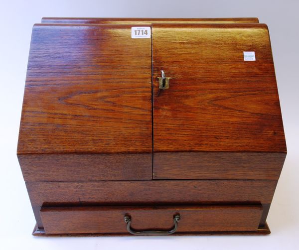 A Victorian oak slop front stationery box, with fitted interior over single drawer, 39cm wide. Property from the estates of the late Adrian Stanford a