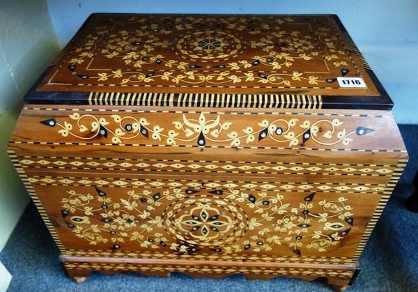 A large 20th century mother of pearl and marquetry inlaid cedar casket of Islamic design, the canted rectangular top revealing a triple lidded interio