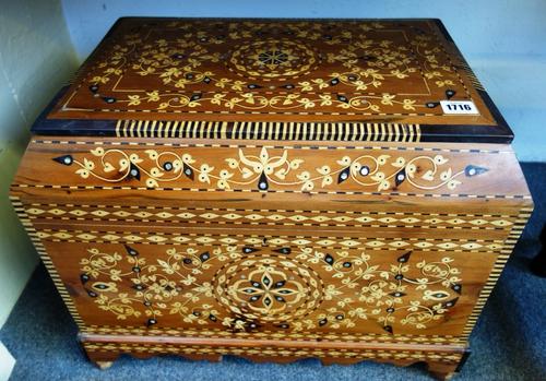 A large 20th century mother of pearl and marquetry inlaid cedar casket of Islamic design, the canted rectangular top revealing a triple lidded interio