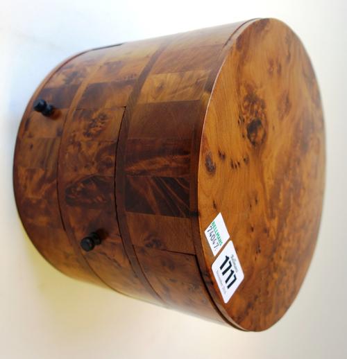 A 20th century amboyna circular jewellery box, with three frieze drawers, 33cm wide.