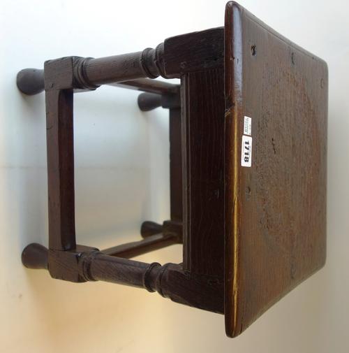 A 17th century and later oak child's stool, the square top on turned supports united by perimeter stretcher, 35cm wide.