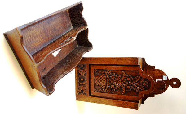 A George III carved walnut wall mounted candle box, with lift front, 21cm wide, together with an early 19th century twin division cutlery tray (2).
