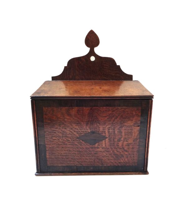 A George III oak wall mounted salt box, with fret carved back over slope front lid, 27cm wide. Illustrated.