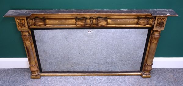 A William IV gilt framed rectangular wall mirror, with lappet carved split column decoration and ebonised slip, 133cm wide x 72cm high.