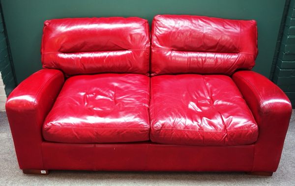 A 20th century sofa upholstered in red leather, on block feet, 178cm wide.