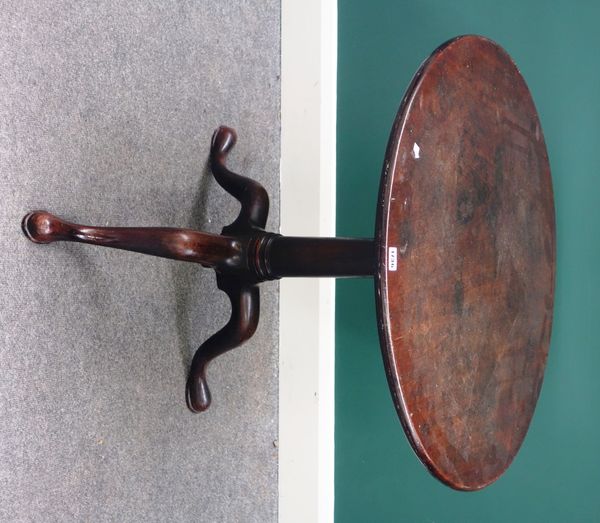 A mid-18th century mahogany occasional table, the circular snap top on bird cage mount and tripod base, 76cm wide.