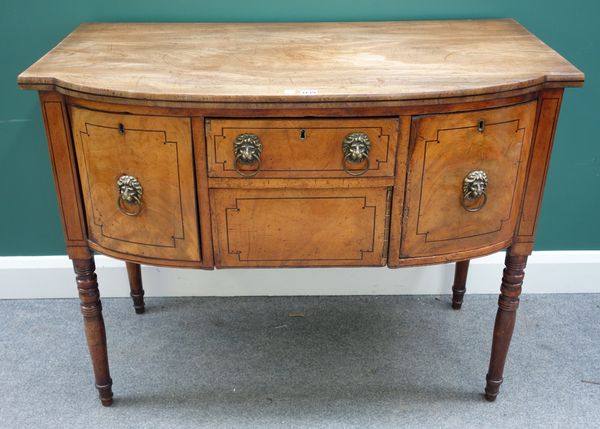 An early 19th century small mahogany bowfront sideboard with an arrangement of three drawers and a cupboard, on turned supports, 107cm wide.