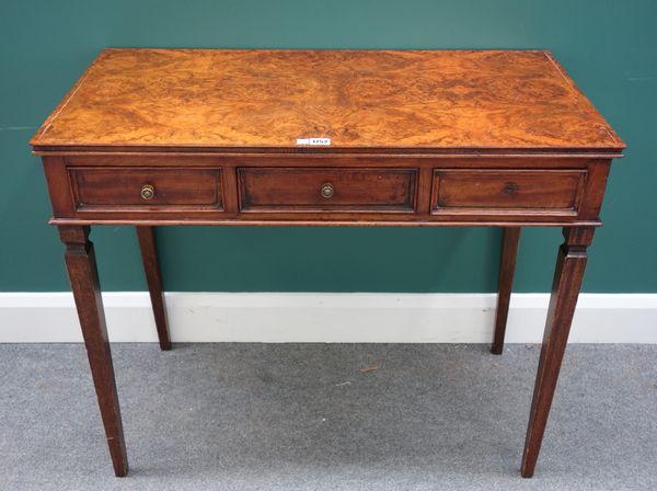 A 19th century Continental figured walnut three drawer writing table, on tapering square supports, 91cm wide.