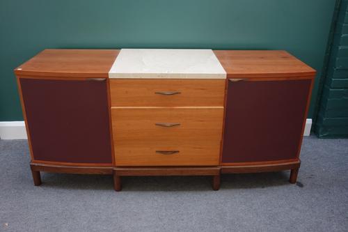 'Senior' Carmichael; a 20th century cherry and polished stone side cabinet, with three central drawers flanked by cupboards, on turned feet, 161cm wid