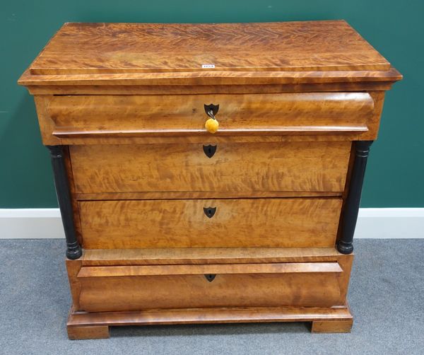 A 19th century Biedermeier birch commode, the four drawers flanked by ebonised turned columns, on block feet, 95cm wide.