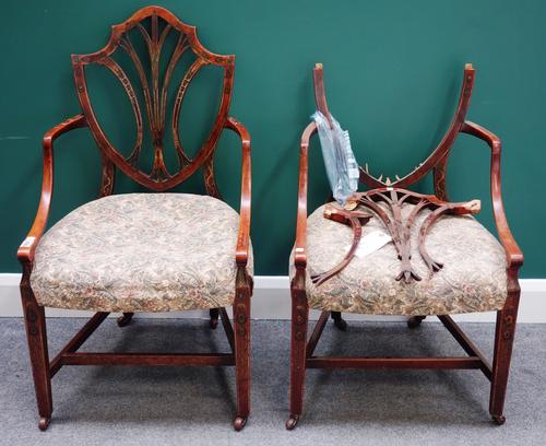 A pair of George III painted satinwood shield back open arm dining chairs, with bowfront seats, on tapering square supports (2).