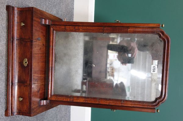 A mid 18th century walnut swing frame toilet mirror, with shaped arch plate over three small drawers, 45cm wide.