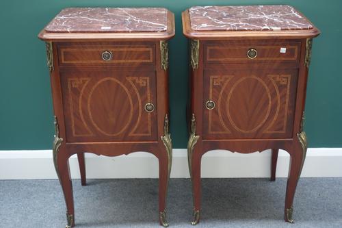 A pair of Louis XV style bedside tables, the rouge marble tops over a gilt metal mounted kingwood banded mahogany base, with single drawer over cupboa