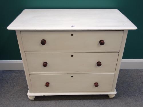A 19th century later cream painted chest of three long drawers, on turned feet, 95cm wide.