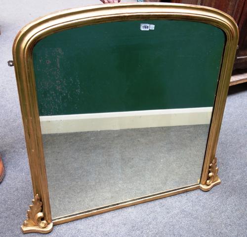 A Victorian gilt framed arch top overmantel mirror, with acanthus scroll mounts, 107cm wide x 99cm high.
