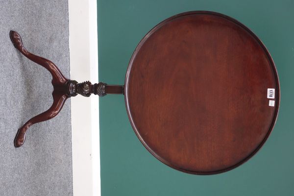 A George III mahogany occasional table, the dished circular snap top on turned and spiral fluted column and tripod base, 56cm wide.