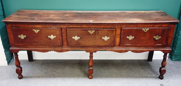 A late 17th century oak dresser base, with three frieze drawers on baluster supports, 200cm wide.