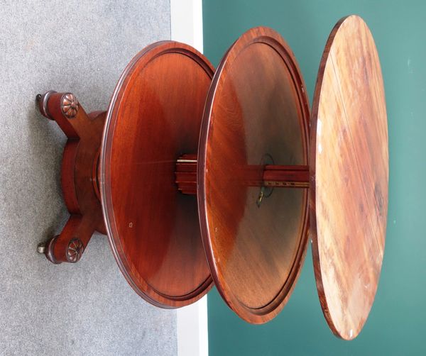 A William IV mahogany circular dumb waiter, morphing to three tiers, on circular platform and four outstepped Tudor rose capped feet, 90cm wide.