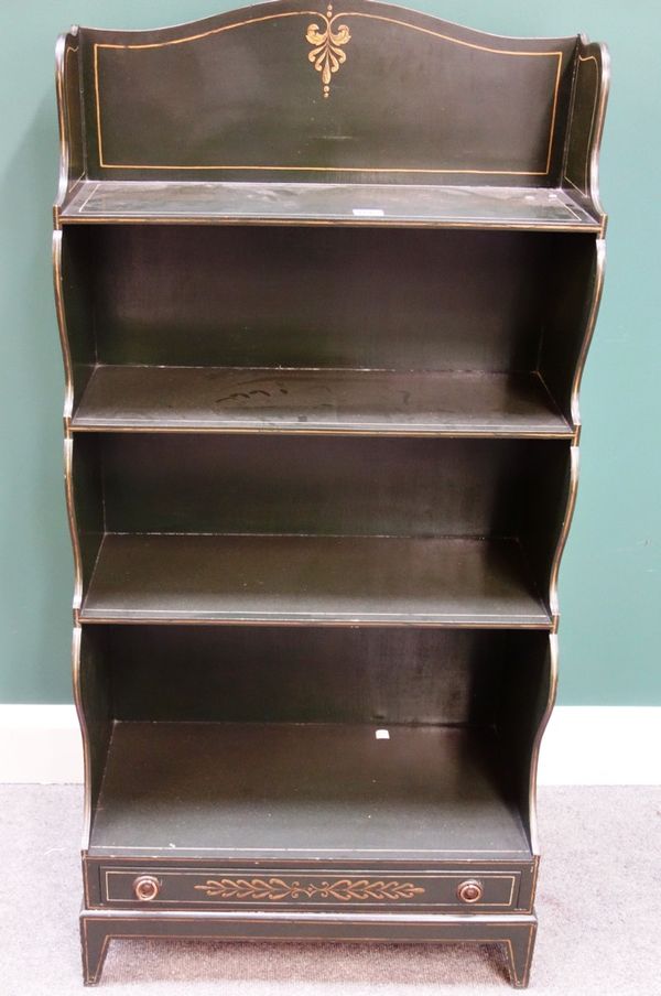 A Regency style parcel gilt green painted waterfall four tier bookcase with single drawer base on bracket feet, 60cm wide.