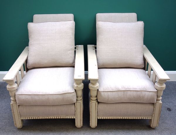 A pair of mid 20th century green painted easy armchairs, with adjustable backs (2).