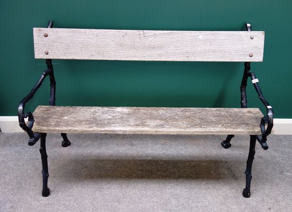 A 19th century black painted cast iron garden bench, of naturalistic branch form, 135cm wide.